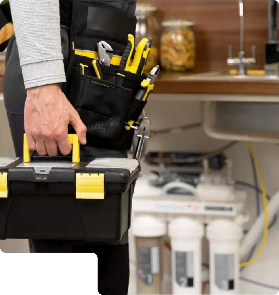 Plumber carrying a toolbox while preparing for a residential plumbing service.